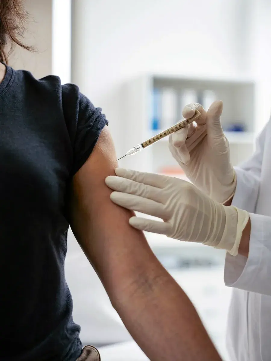 A clinician giving a gentle intramuscular vitamin injection — Stilwell Wellness Solutions wellness injections.